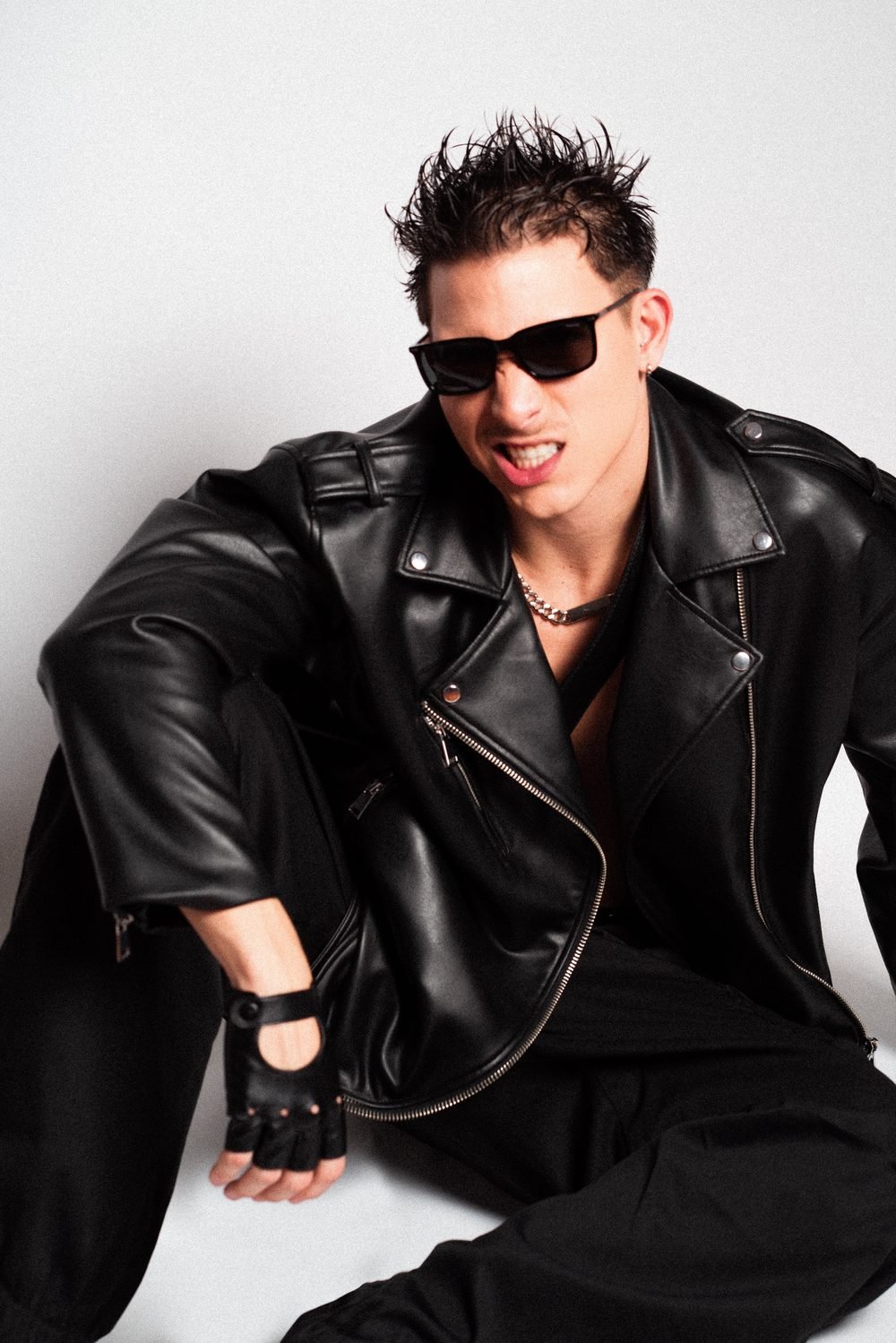 Lucas Gavvi in a leather jacket and sunglasses in the studio